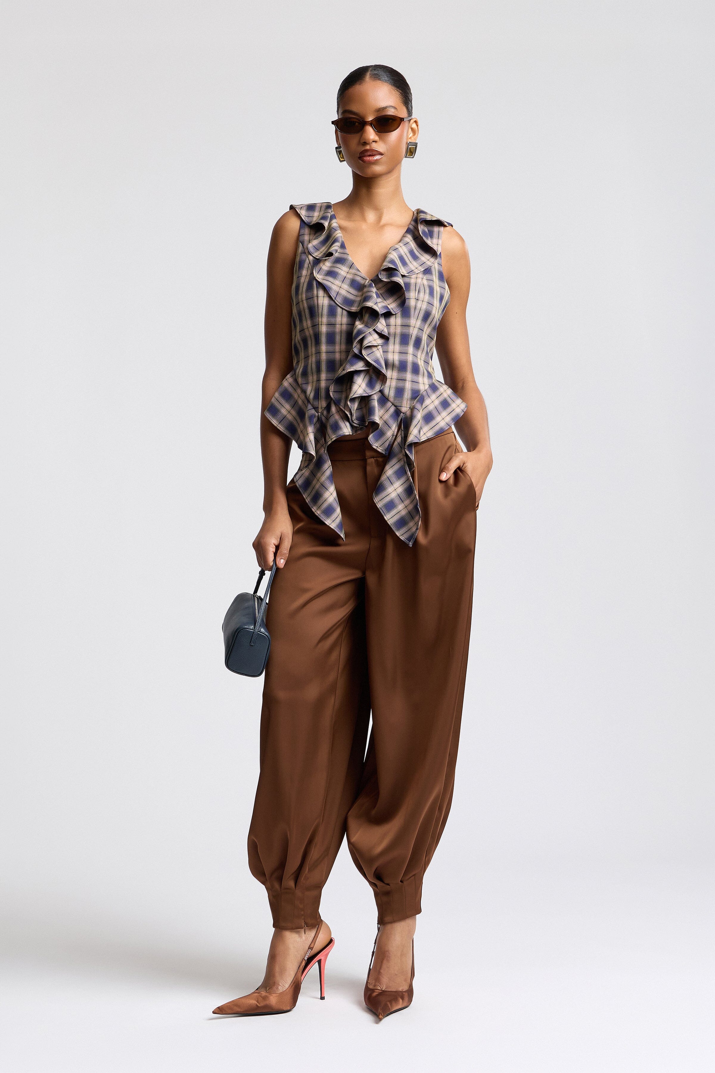 Twilight navy and taupe sleeveless ruffle plaid blouses. Shop designer women's fitted tops by Avec Les Filles. 