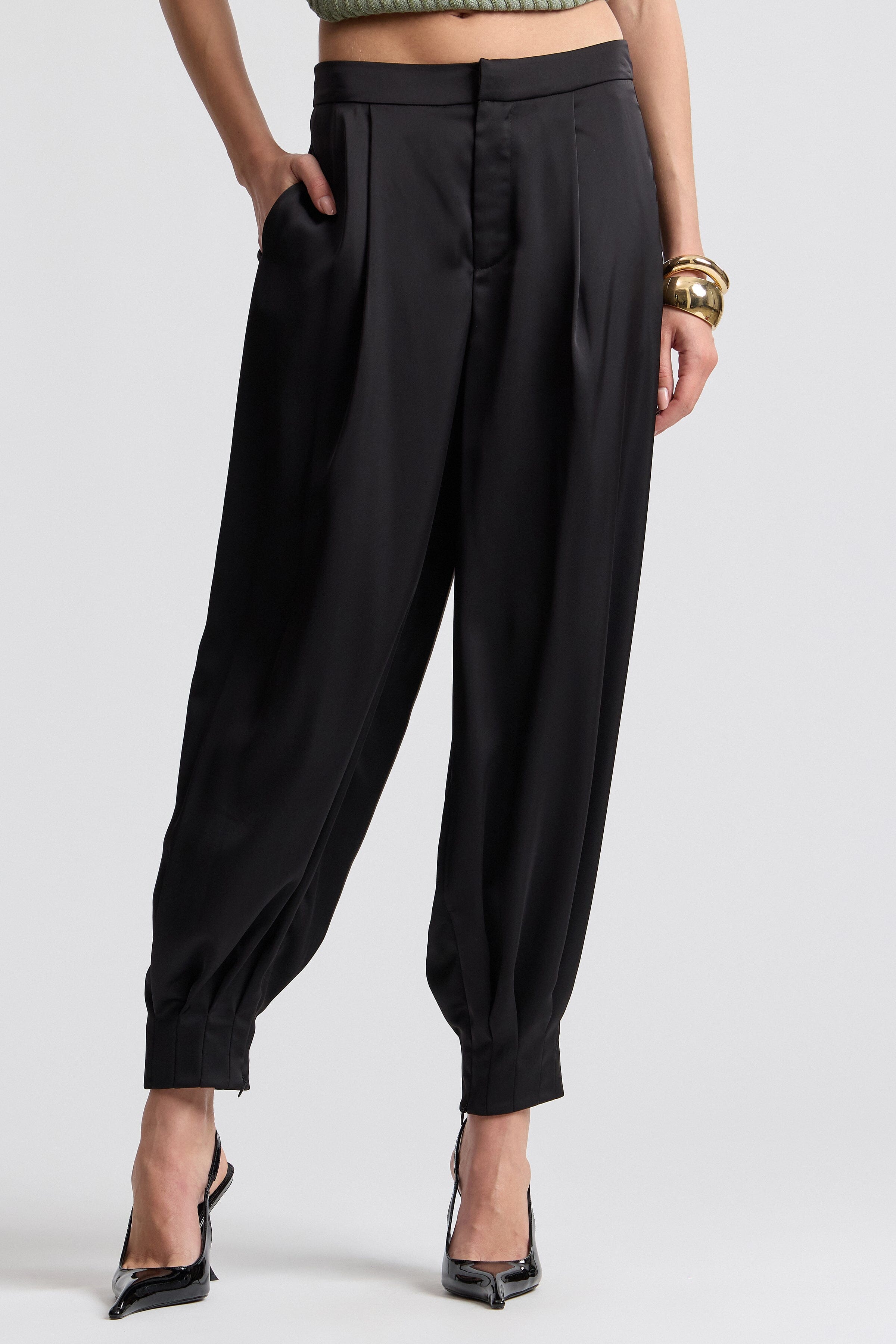 Black pleated satin balloon pants. Shop designer women's pants by Avec Les Filles.
