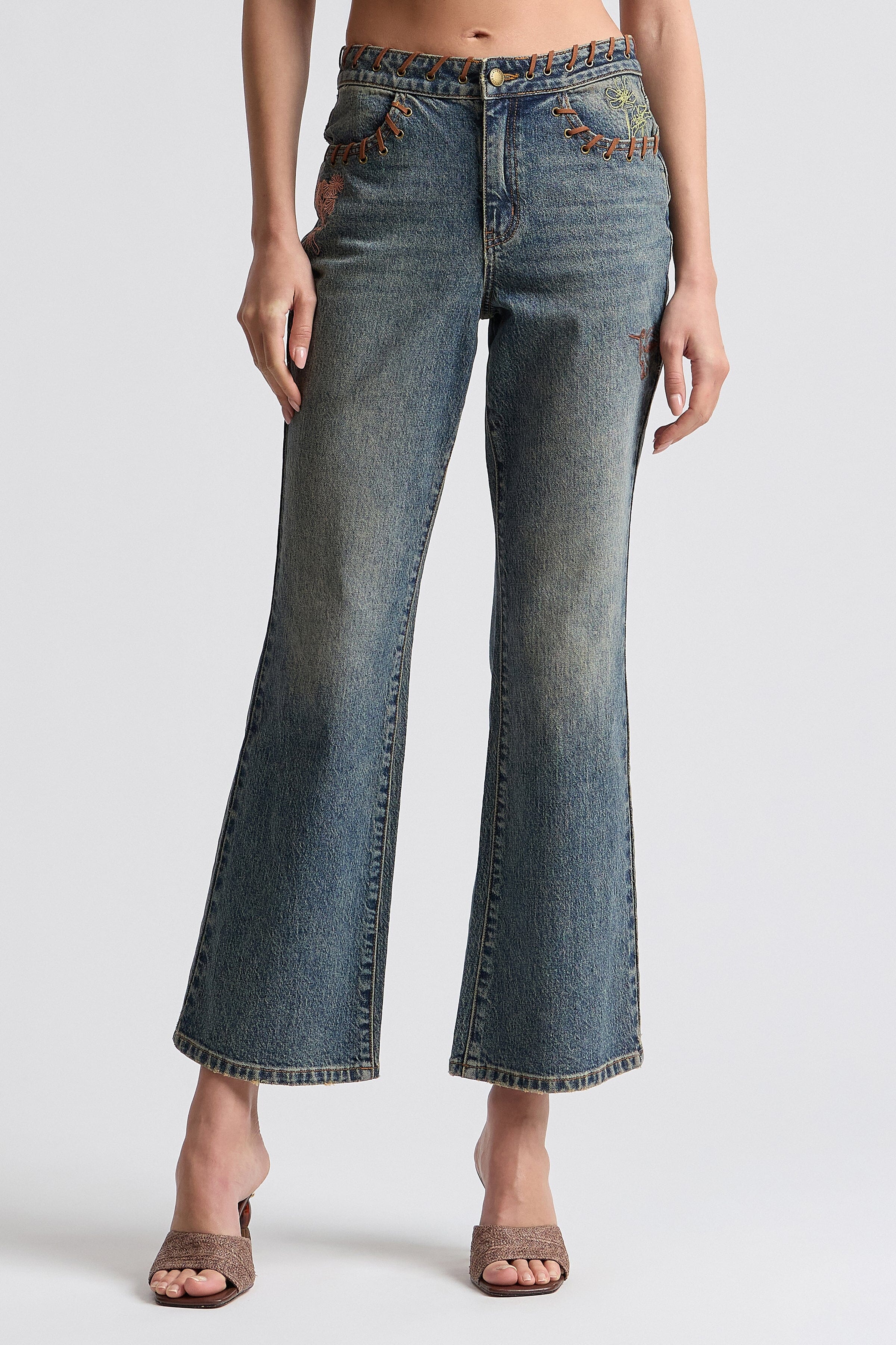 Vintage-inspired 70's style embroidered flared jeans - Shop designer women's high-rise flared denim jeans.