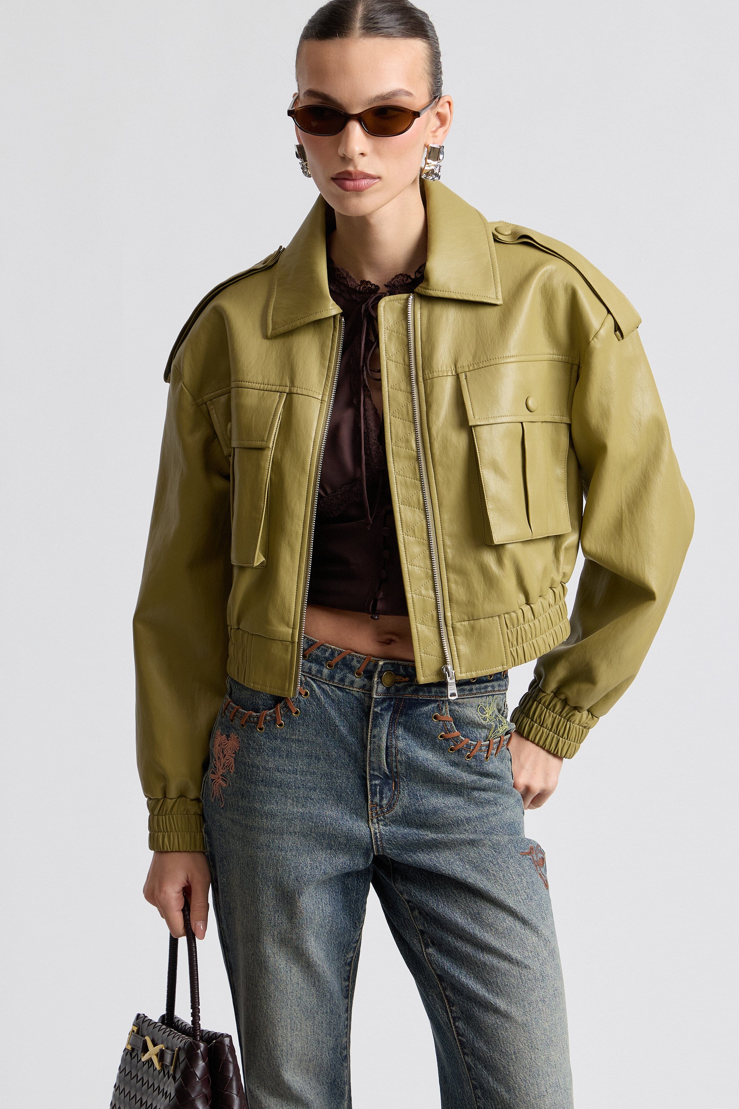 Oversized faux leather green bomber jacket with strong shoulder pads and elasticised waistband by Avec Les Filles