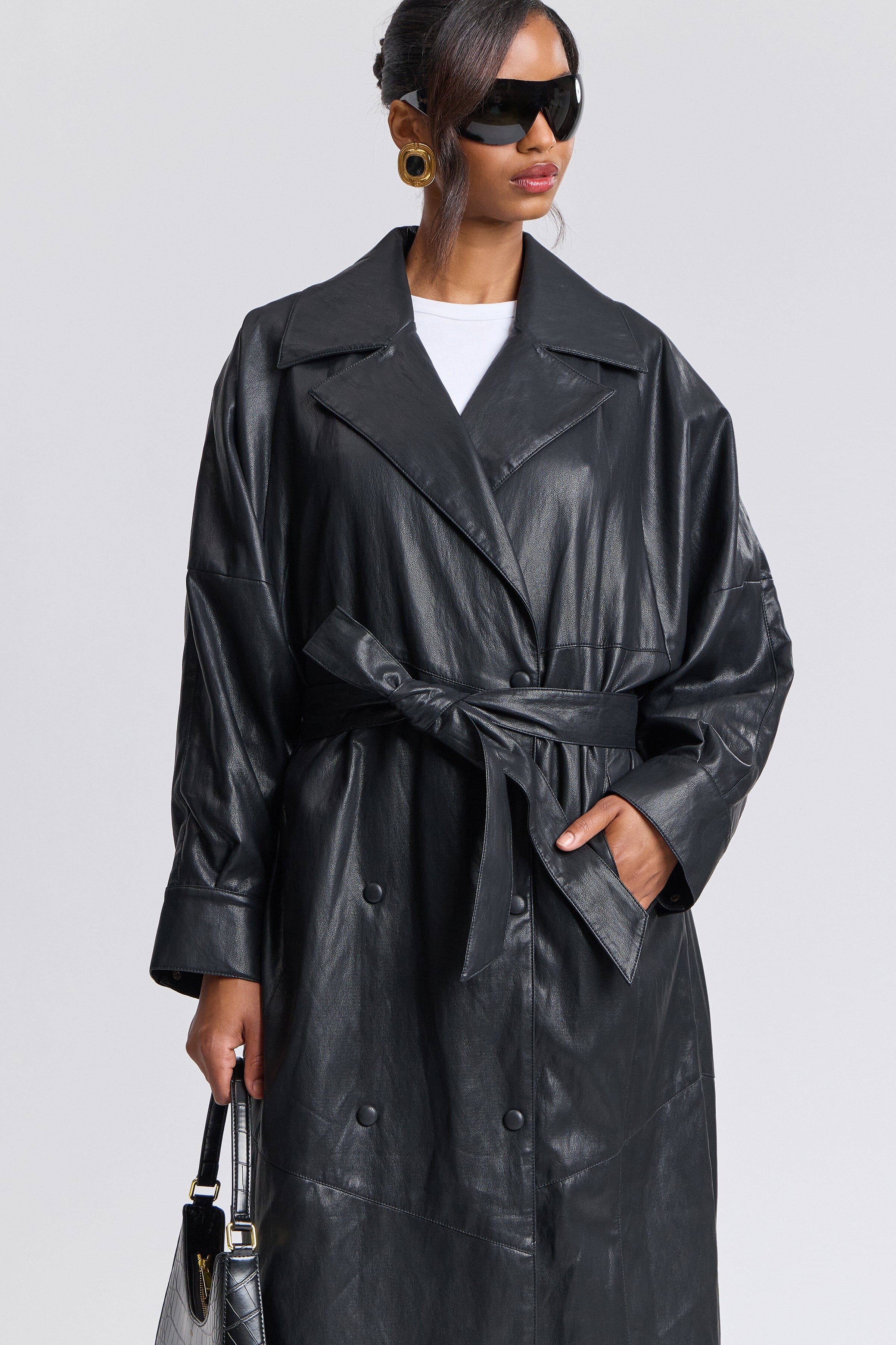 Double-breasted button-front black faux leather trench with adjustable belt - Shop cute trench coats by Avec Les Filles.