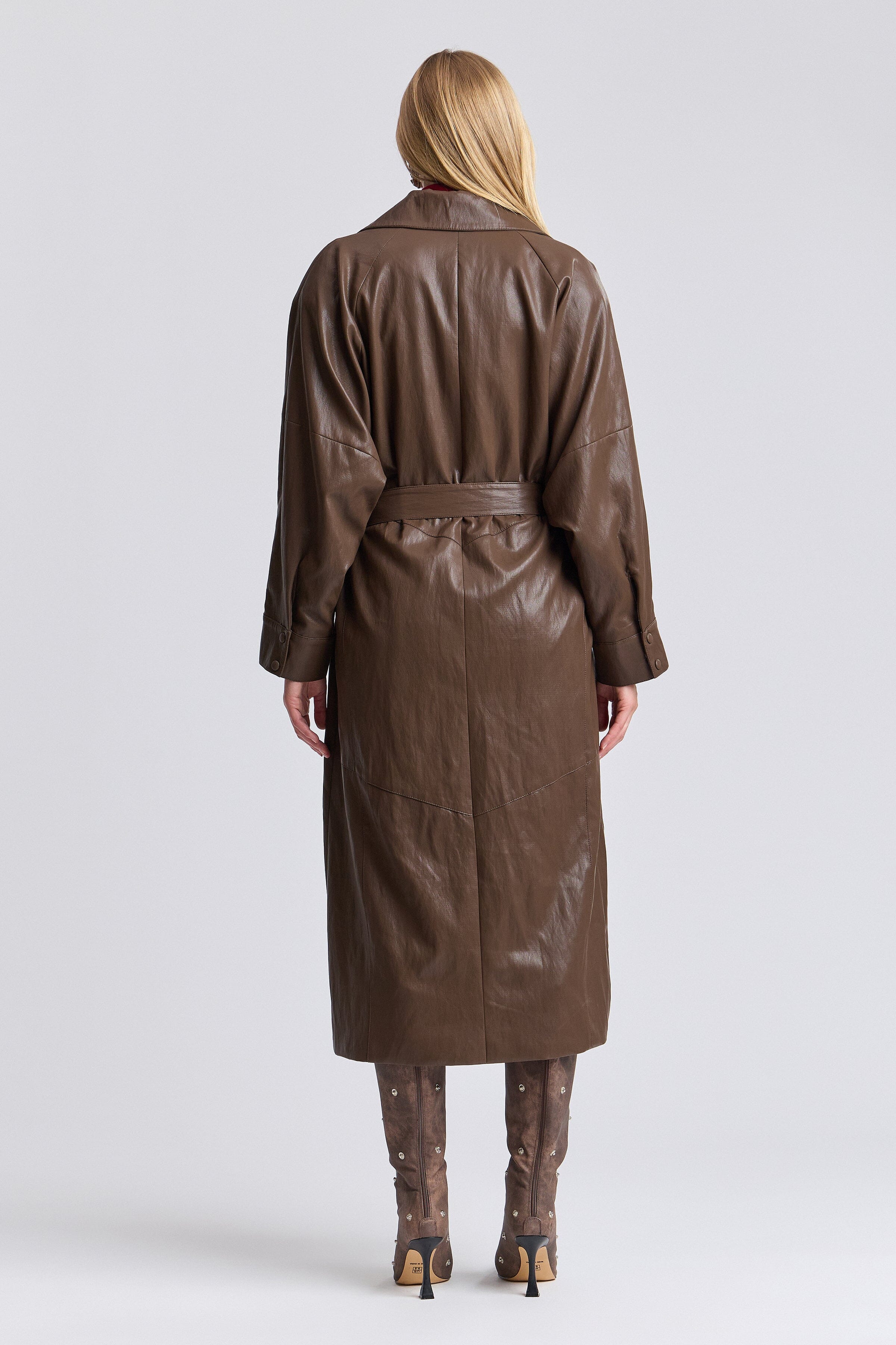 Brown faux leather trench coat with point collar and adjustable belt. Shop women's cute trench coats by Avec Les Filles.