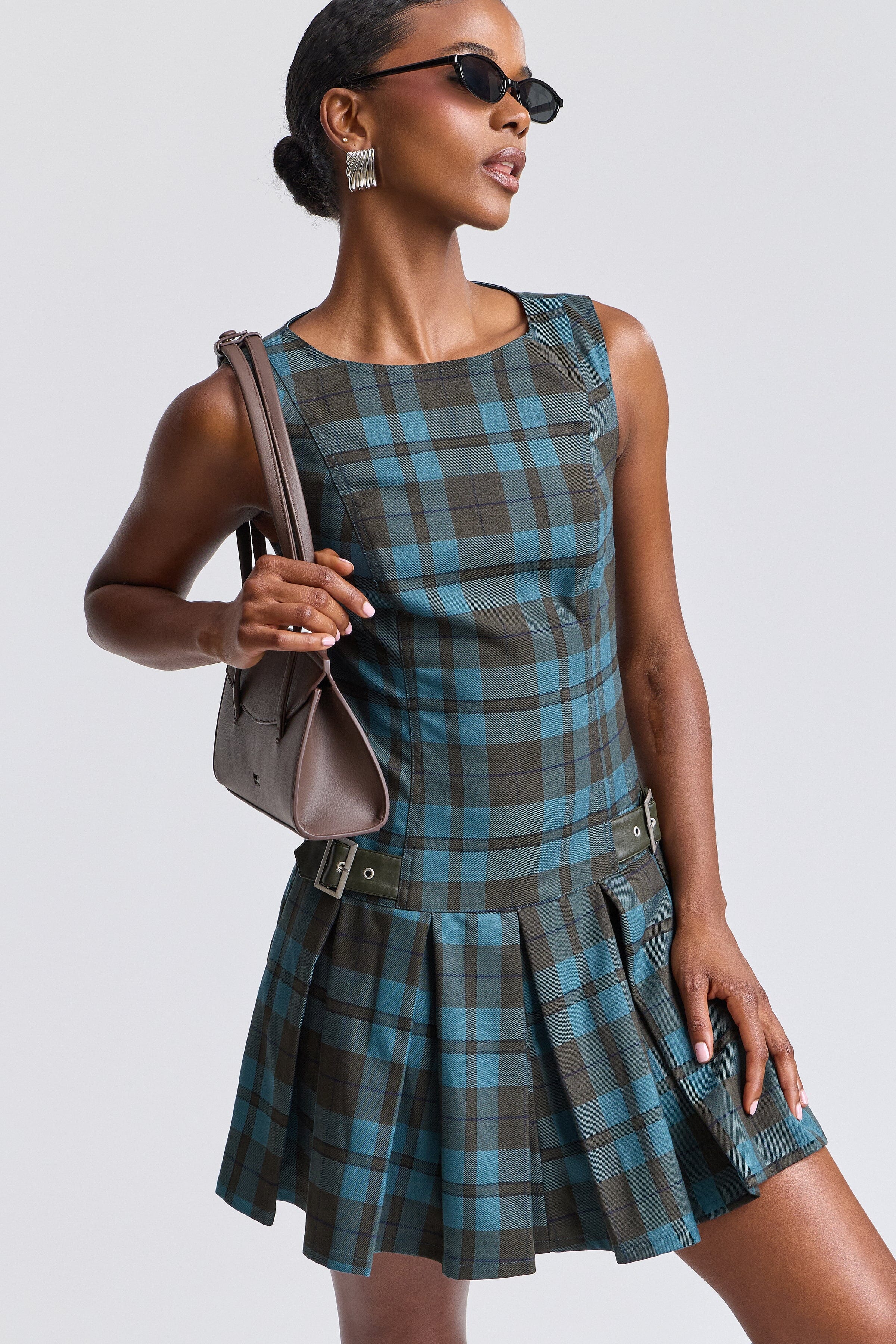 Sleeveless blue mini dress plaid with pleated drop-waist and boat neckline. Shop cute mini dresses by Avec Les Filles.