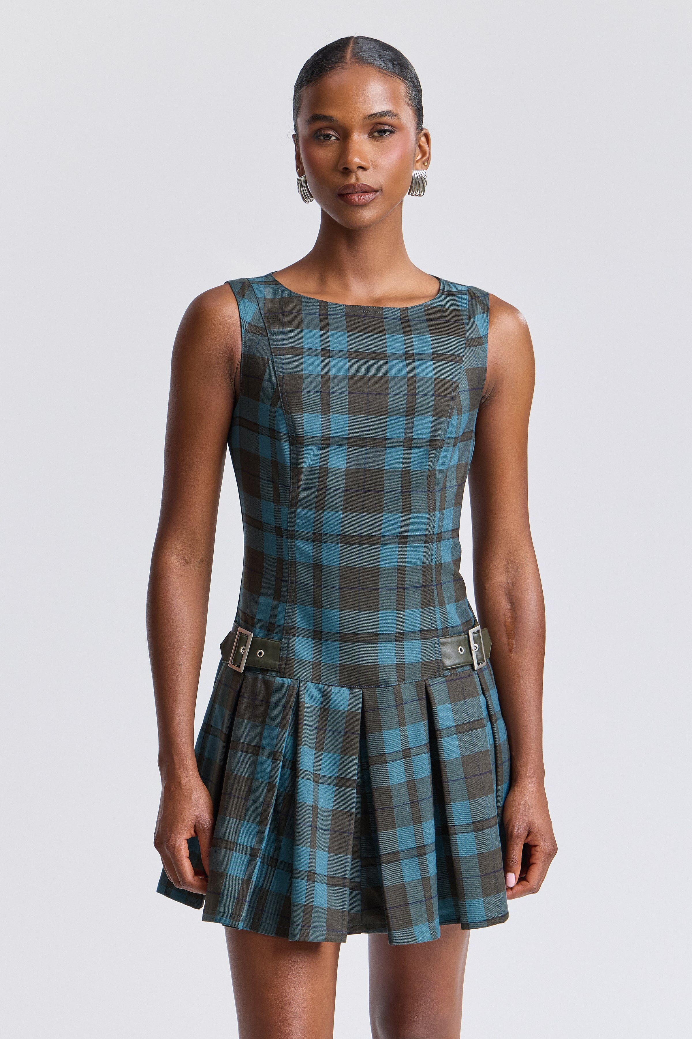 Sleeveless blue plaid dress mini with pleated drop-waist and boat neckline. Shop cute mini dresses by Avec Les Filles.