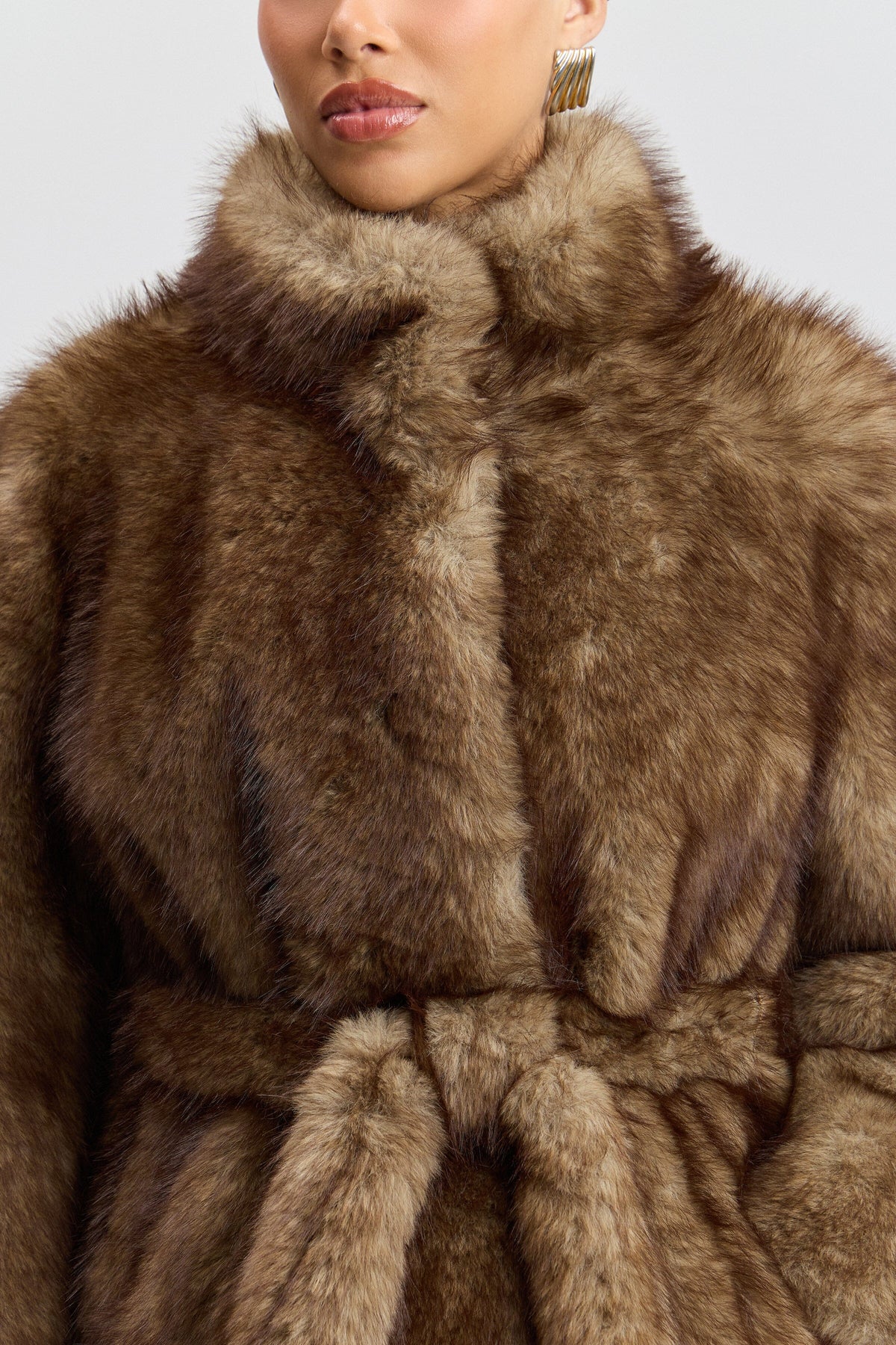 Brown faux fur jacket with a stand collar and removable belt. Shop women's cute faux fur jackets by Avec Les Filles.