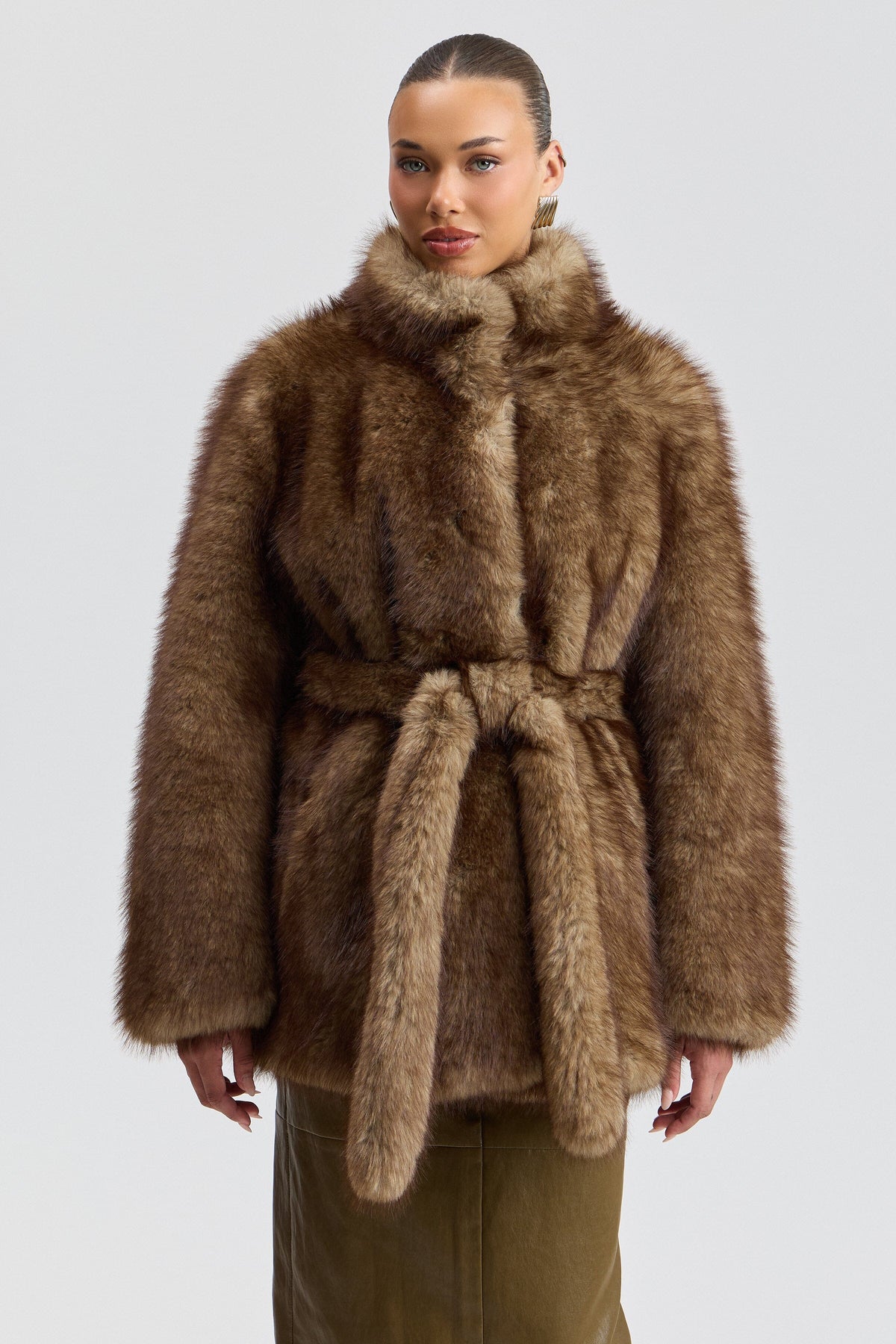 Faux fur long brown coat with a stand collar and removable belt. Shop designer faux fur jackets by Avec Les Filles.