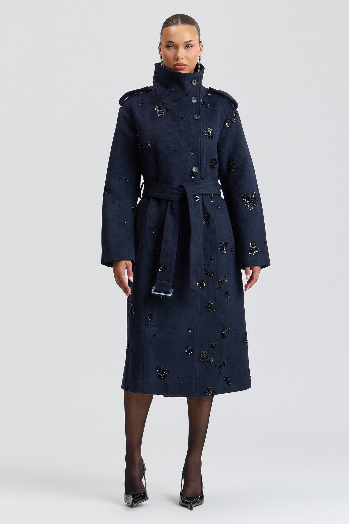 Sequin-embellished navy trench coat with high funnel collar and a belt. Shop women's trench coats by Avec Les Filles.