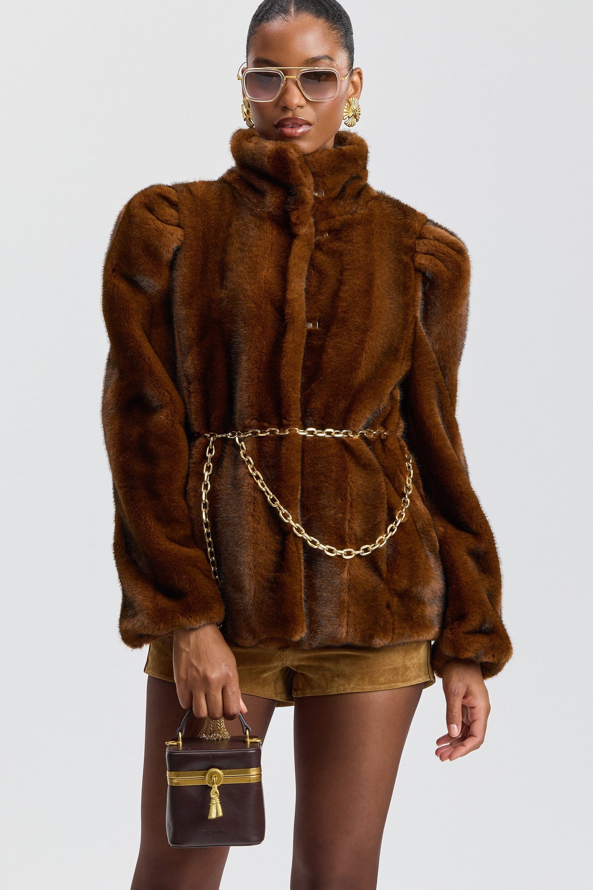 Faux brown fur jacket with chain belt and high stand collar. Shop designer women's cute faux fur jackets by Avec Les Filles.