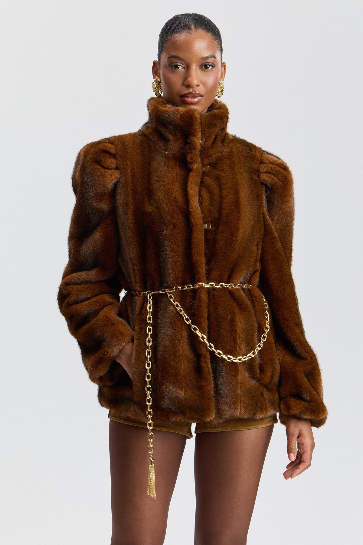 Brown mink puff-sleeve faux fur jacket with chain belt and stand collar. Shop cute faux fur jackets by Avec Les Filles.
