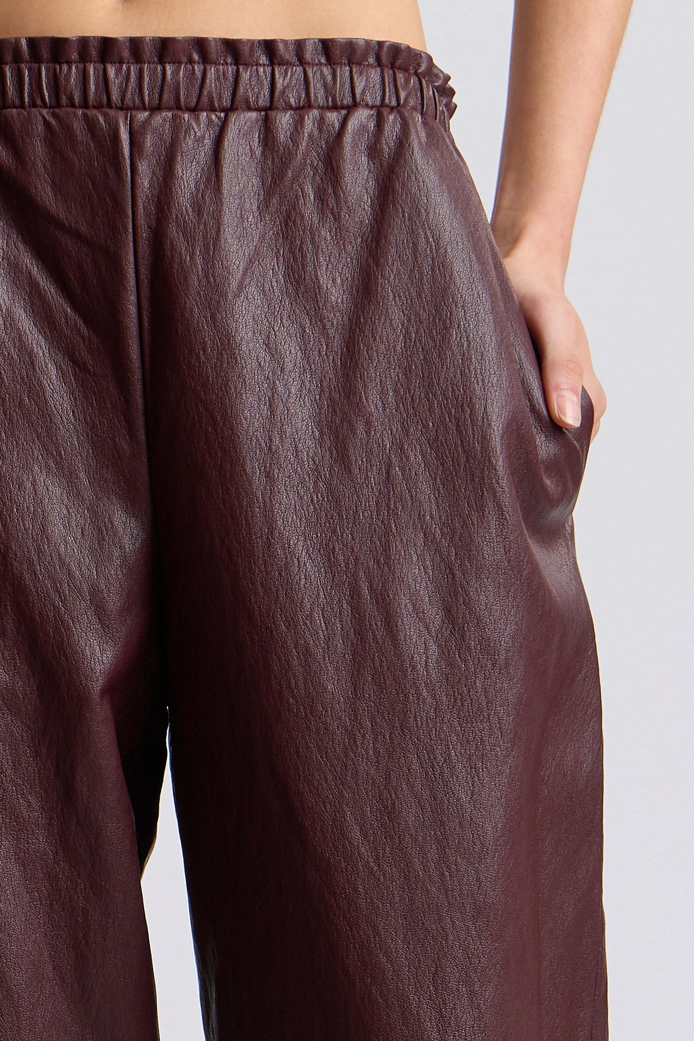 Dark brown faux leather pants with an elastic waistband and mid-rise - Shop women's joggers by Avec Les Filles.