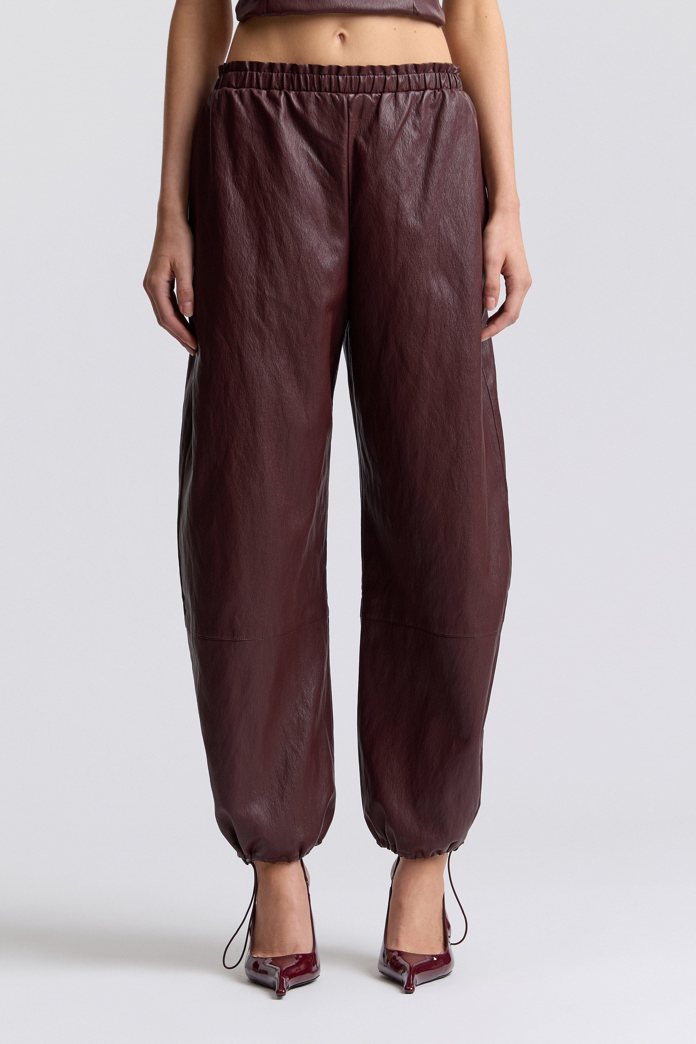 Brown faux leather joggers with an elastic waist and mid-rise - Shop faux leather joggers for women by Avec Les Filles.