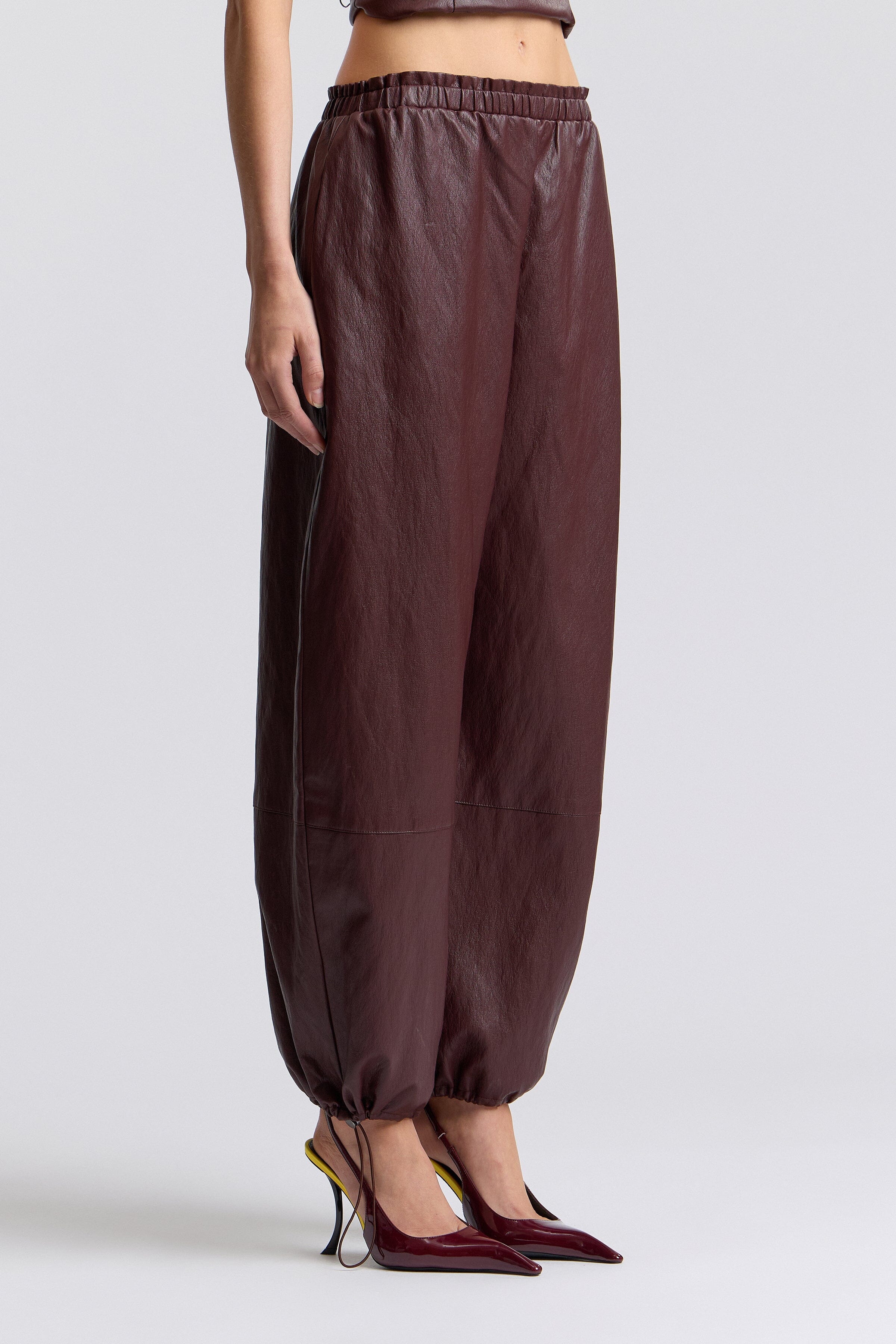 Dark brown women faux leather joggers with an elastic waistband and mid-rise - Shop designer joggers by Avec Les Filles.