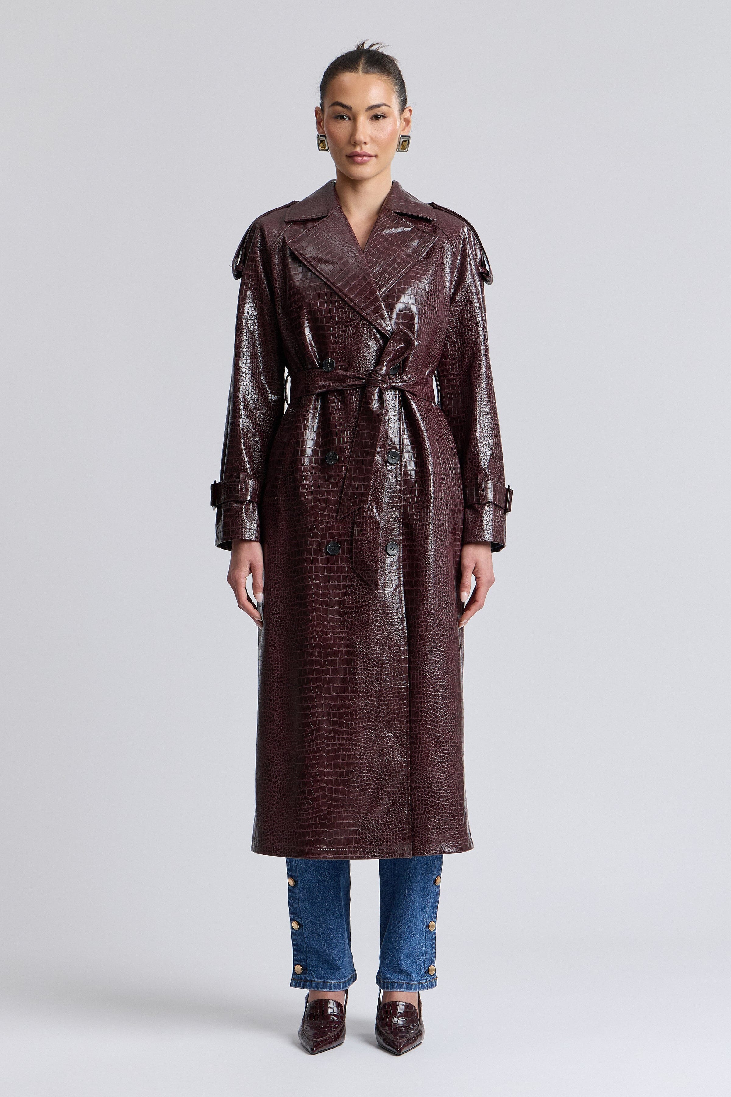 Croc-embossed dark red faux leather trench coat with long sleeves and a removable belt by Avec Les Filles.