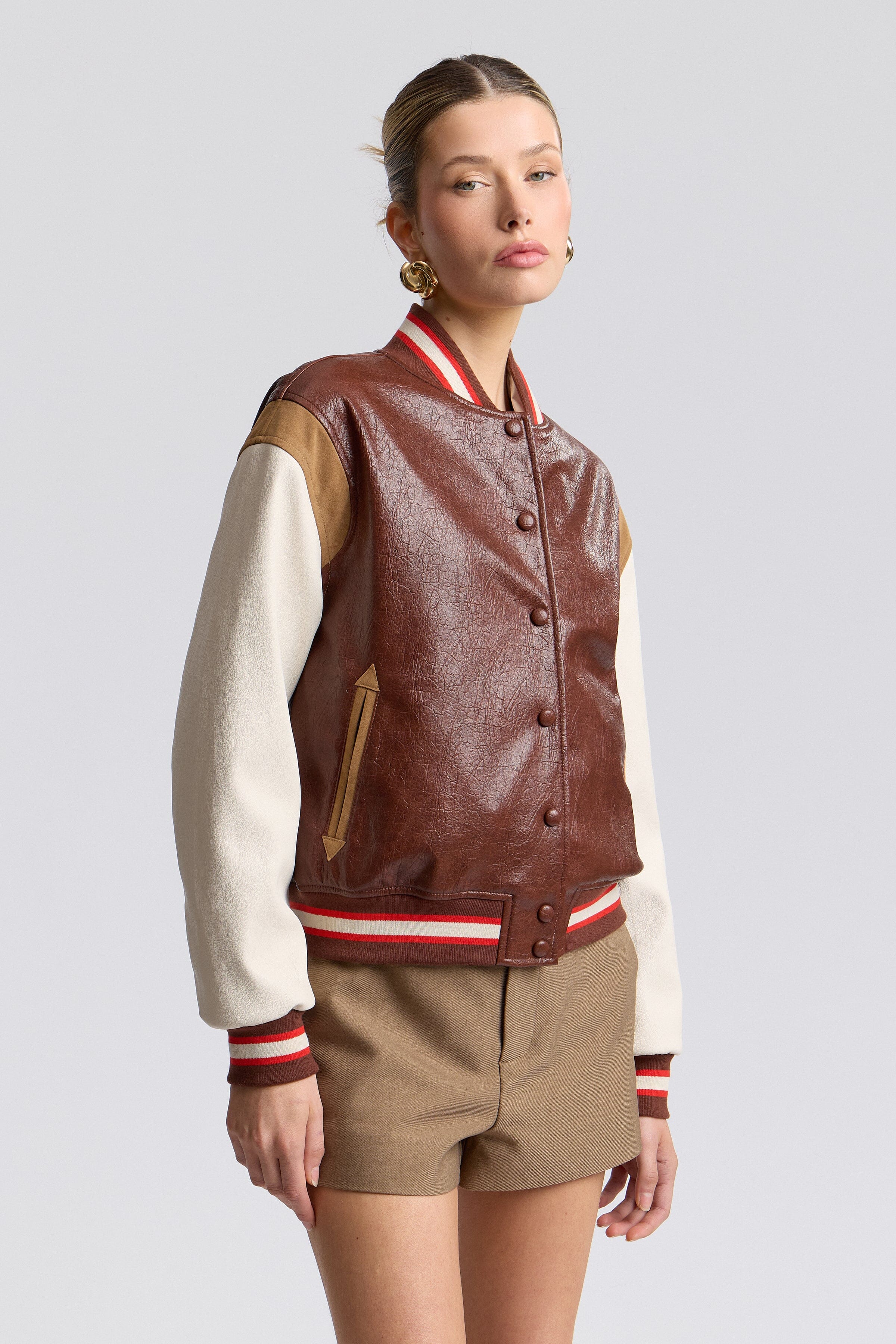 Faux-leather red designer varsity jacket with a snap-button front and long sleeves - Shop cute jackets by Avec Les Filles.