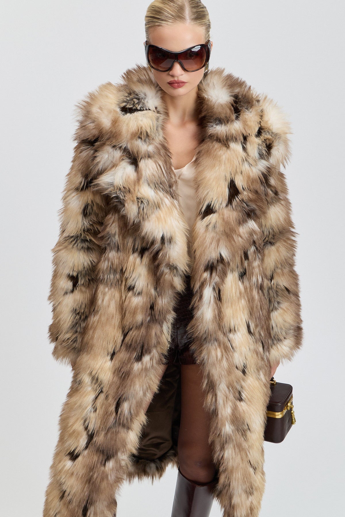 Brown long tan fur coat with side slits and a wide collar. Shop designer women's cute tan fur coats by Avec Les Filles.