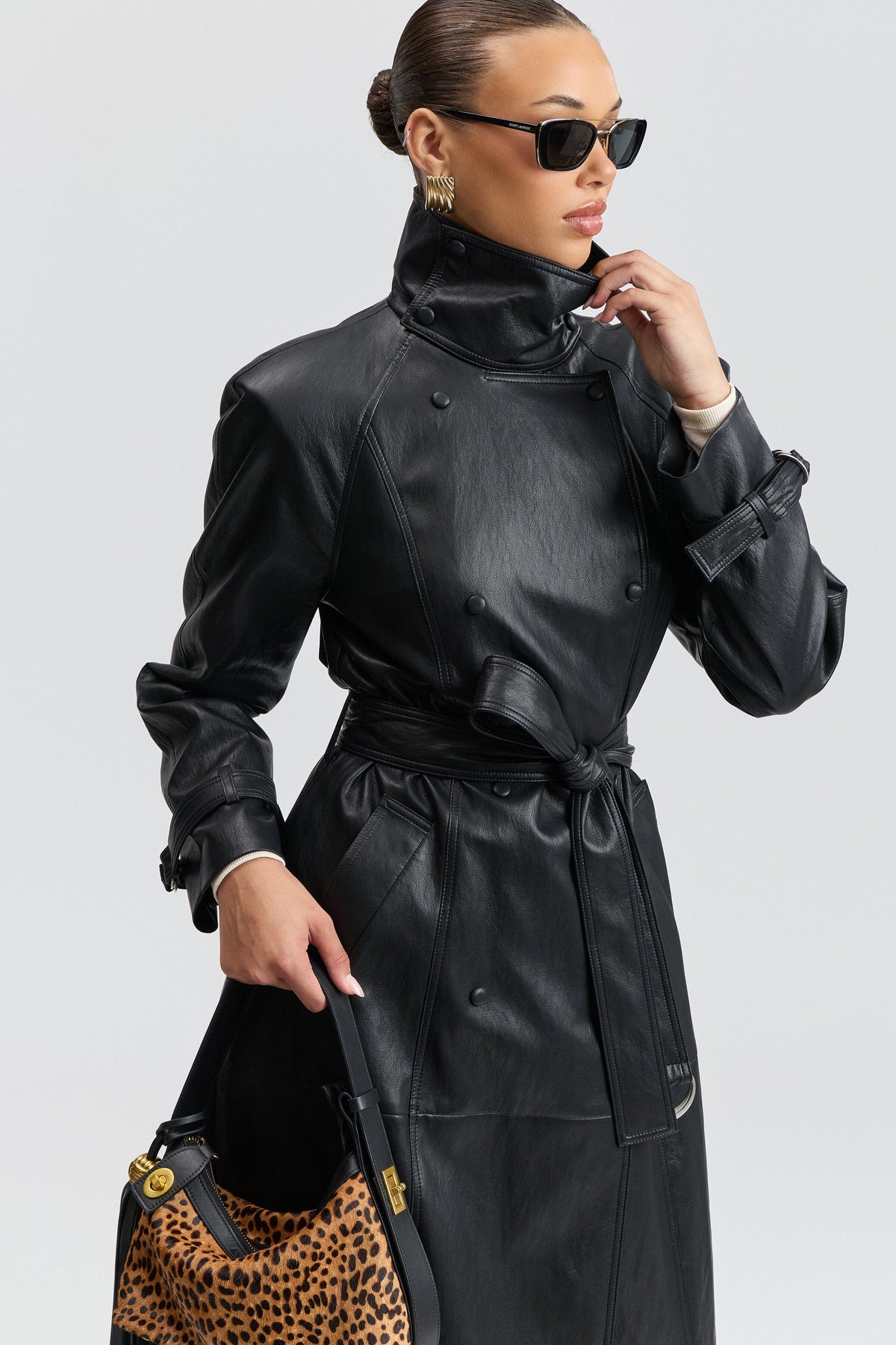 Double-breasted belted black faux leather trench coat with a funnel neck - Shop trench coats by Avec Les Filles.