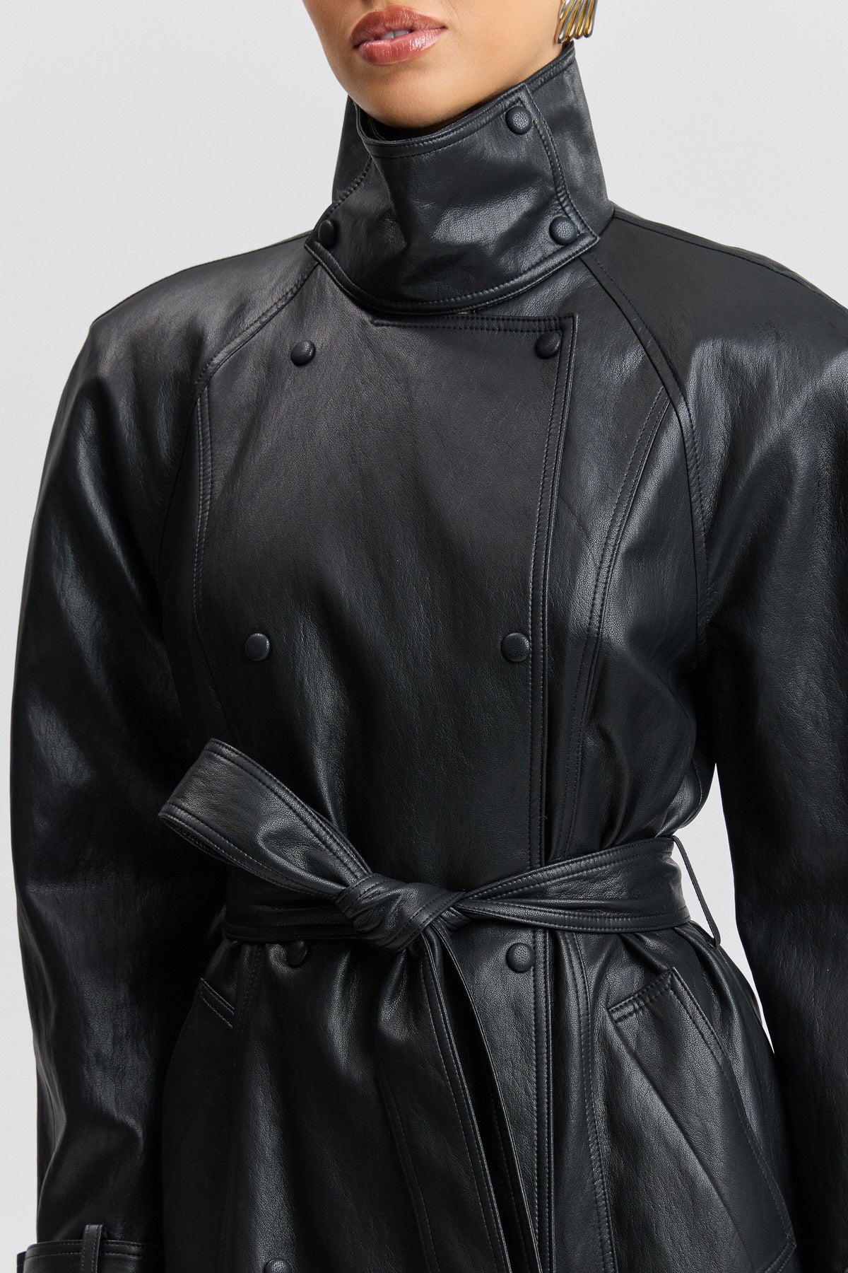 Double-breasted belted long black leather trench coat with a funnel neck - Shop trench coats by Avec Les Filles.