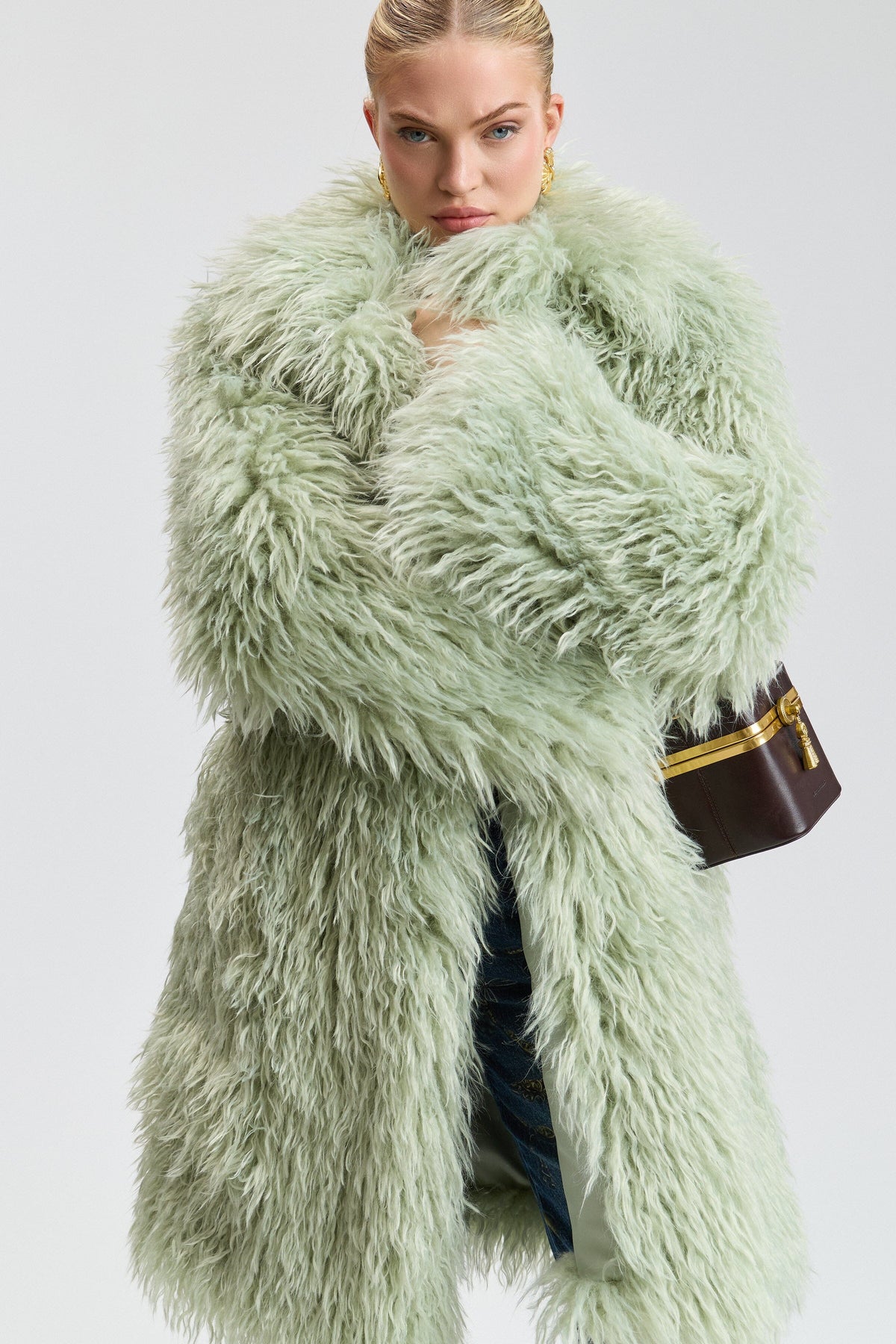 Notch-collar shaggy green fur coat with a center front. Shop designer women's cute green fur coats by Avec Les Filles.