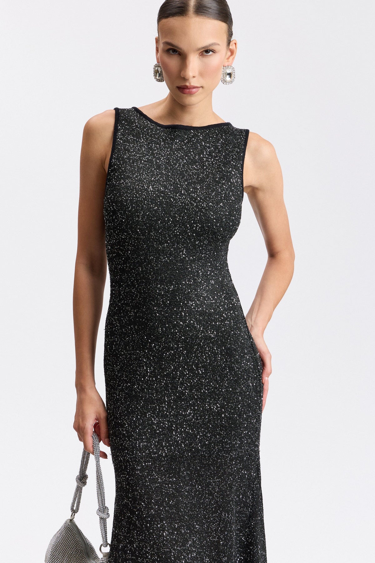Black sequin sweater dress with boat neck and asymmetric hem. Shop evening midi dresses by Avec Les Filles.