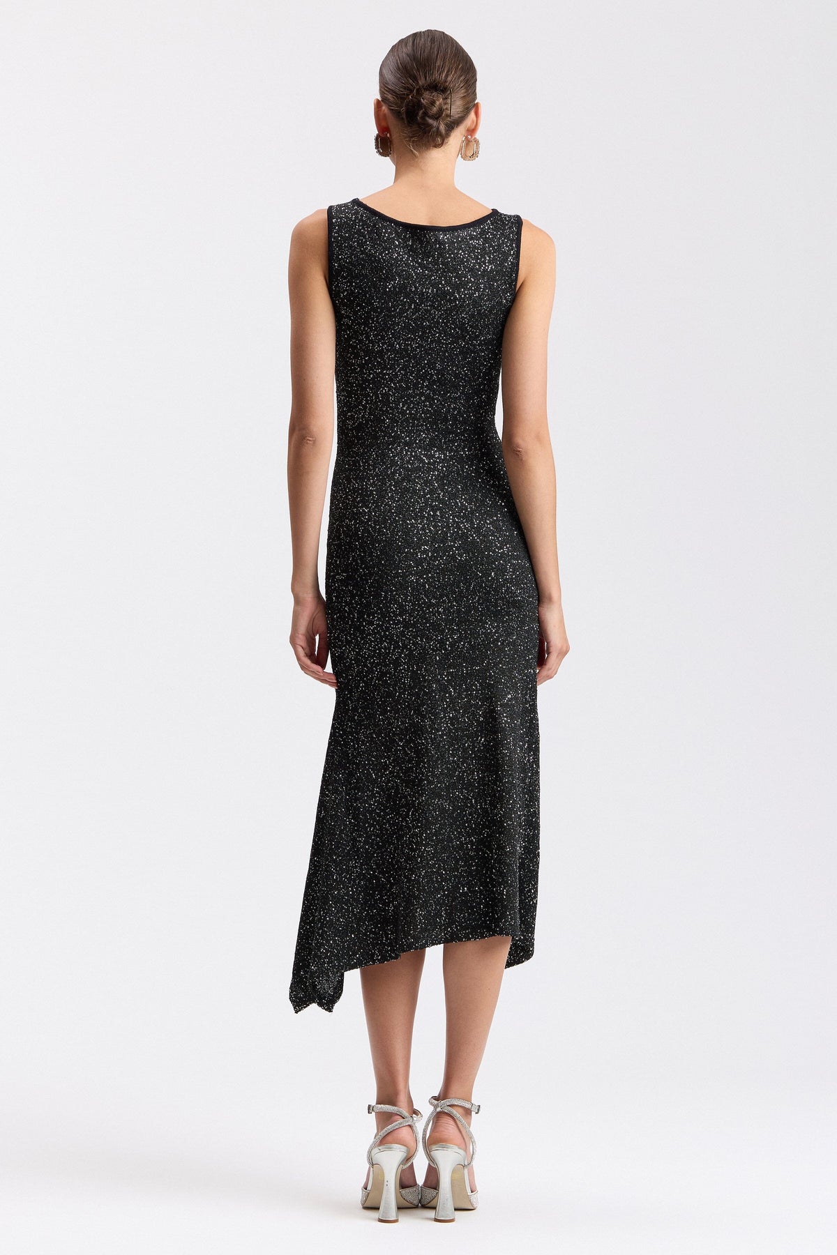 Black sequin sweater dress with an asymmetric hem. Shop evening midi dresses by Avec Les Filles.