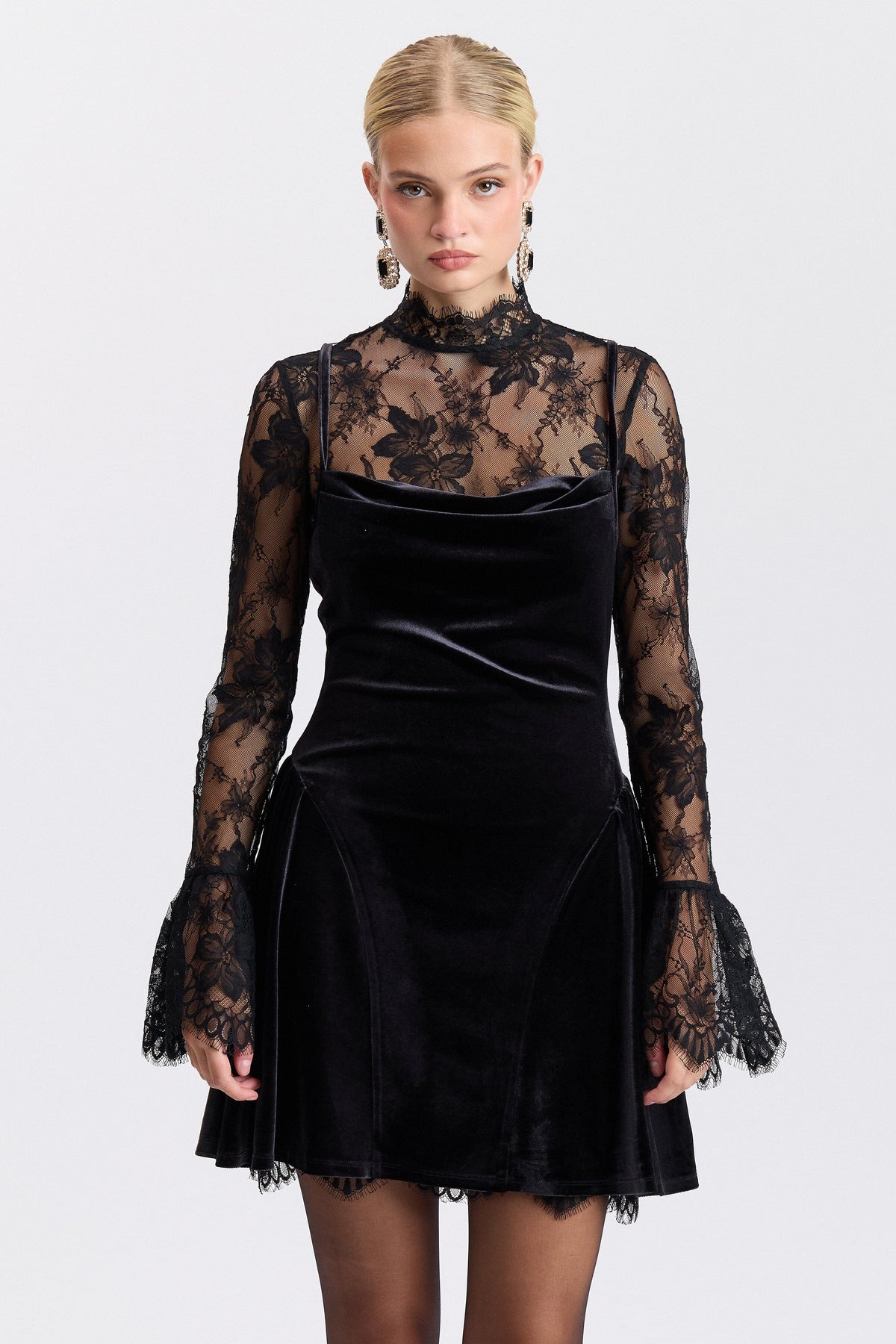 Fit-and-flare black velvet lace dress with a high mock neck and long flared sleeves by Avec Les Filles.