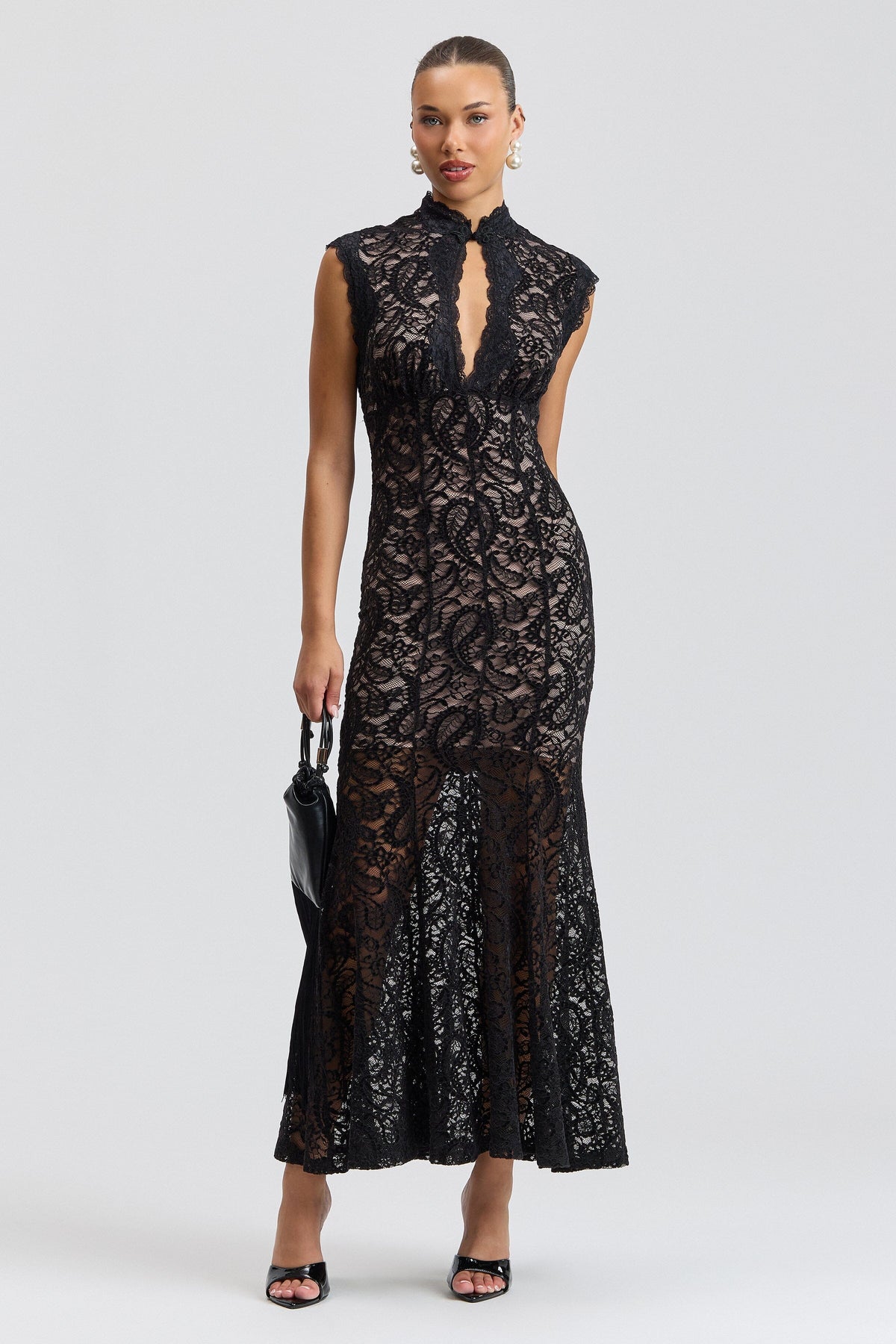 Sleeveless black lace maxi dress with a fitted fluted skirt. Shop designer women's black lace dresses by Avec Les Filles.