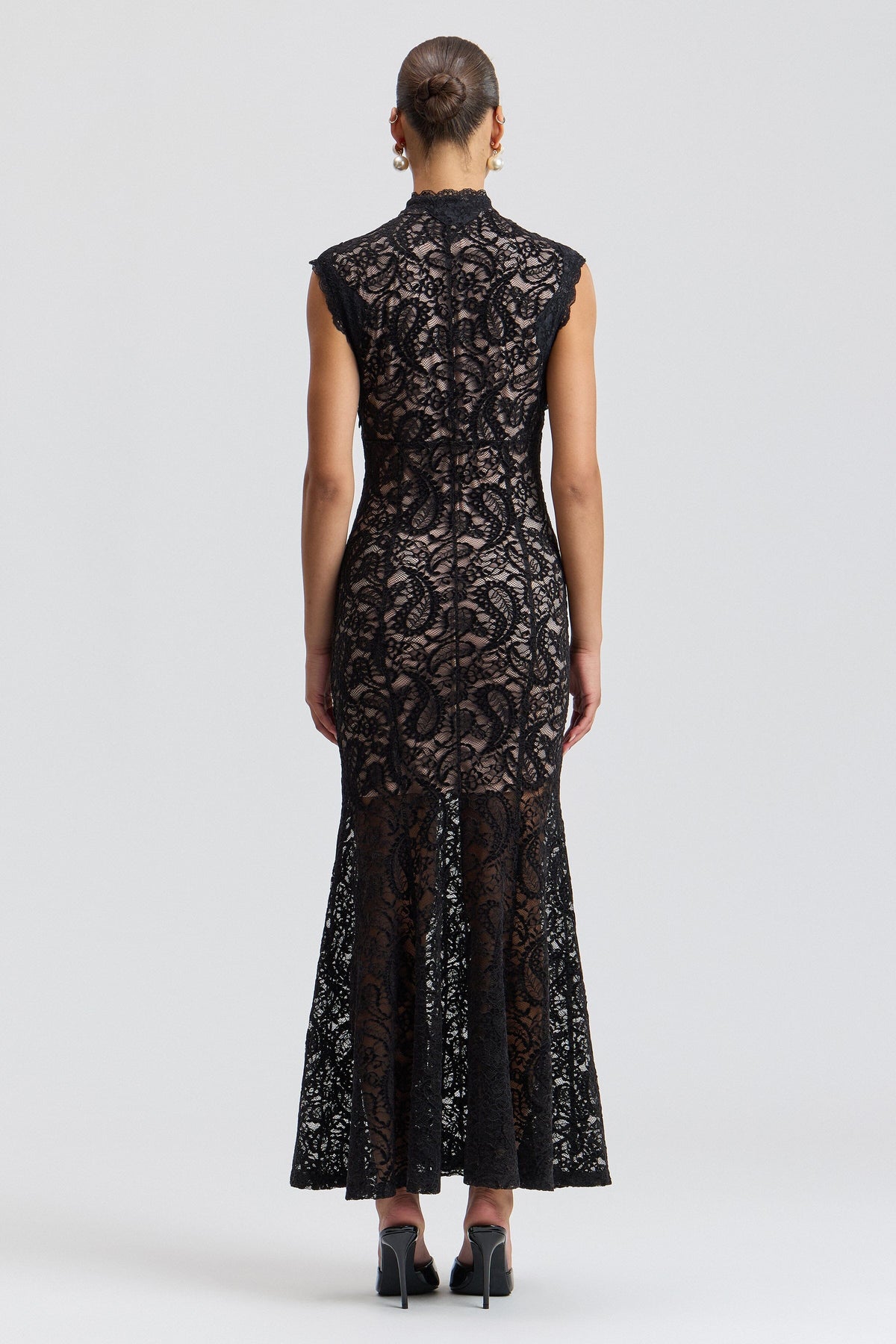Sleeveless lace holiday dress with a fitted fluted skirt. Shop designer women's black lace dresses by Avec Les Filles.
