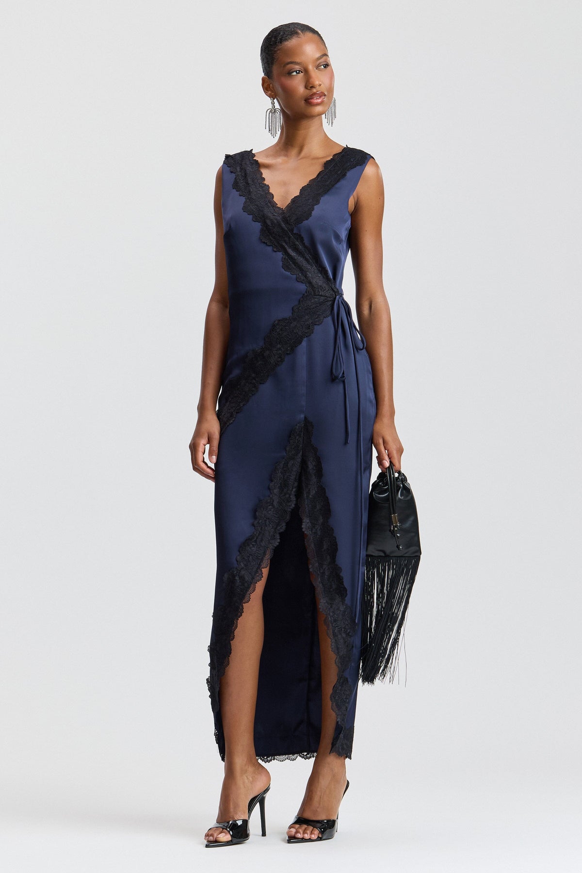 Sleeveless navy blue satin maxi dress with a deep V-neckline and drawstring tie waist by Avec Les Filles.