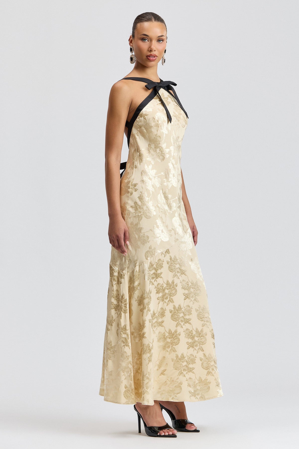 Sleeveless cream maxi satin dress with black satin straps and bow neck. Shop cute backless dresses by Avec Les Filles.