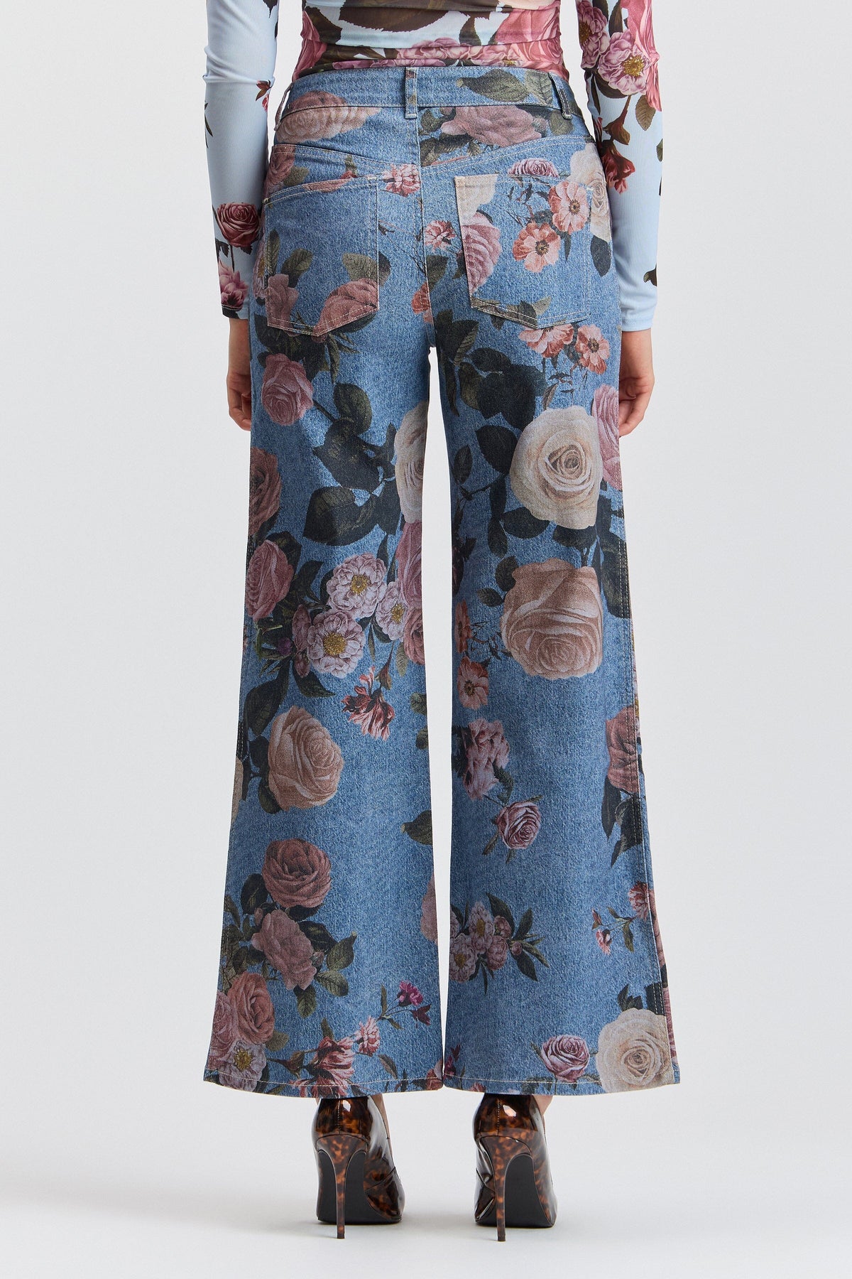 Blue denim flower jeans with a high-rise waist and pockets. Shop women's wide leg denim jeans by Avec Les Filles.