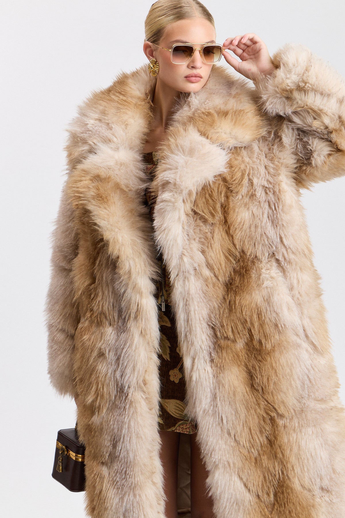 Beige faux fur full length coat with wide collar and button front. Shop women's cute brown long coats by Avec Les Filles.