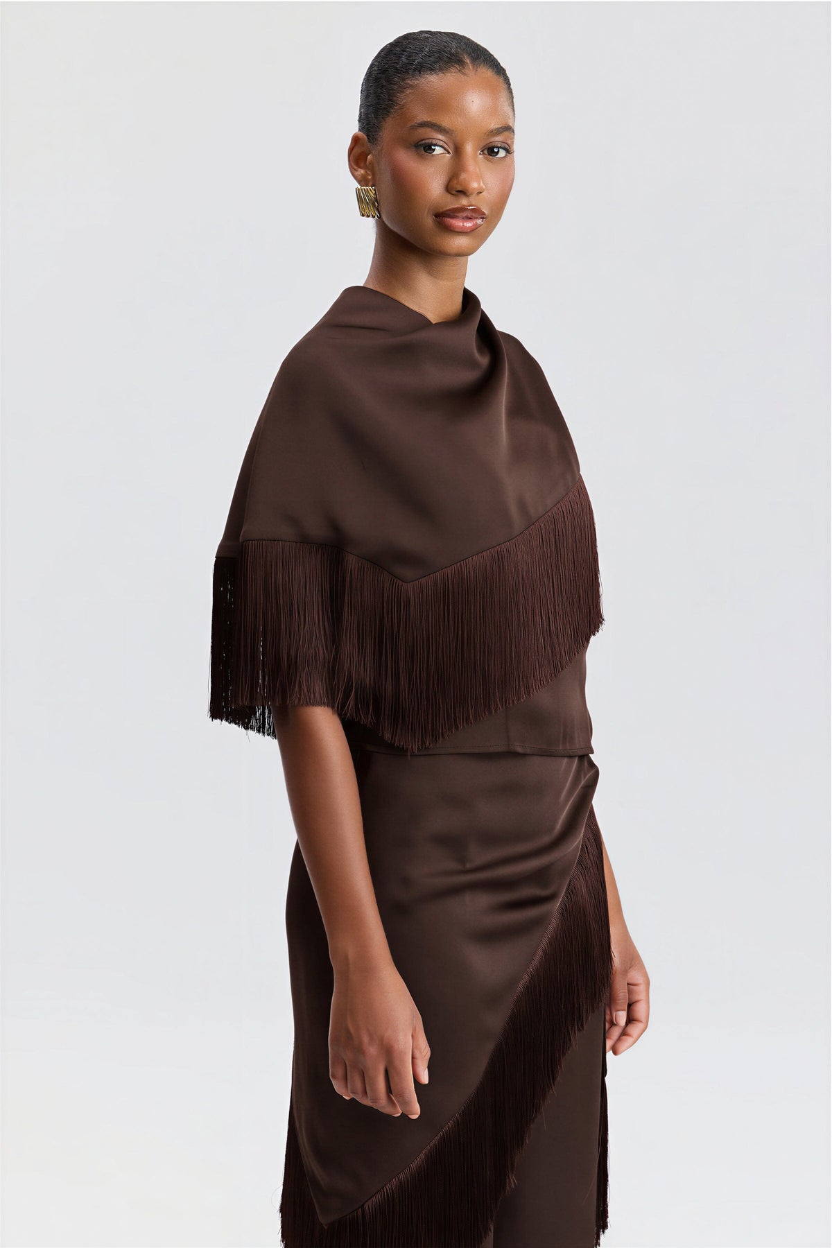Satin brown halter fringe shirt with an asymmetric bandana-style cape. Shop women's brown tops by Avec Les Filles.