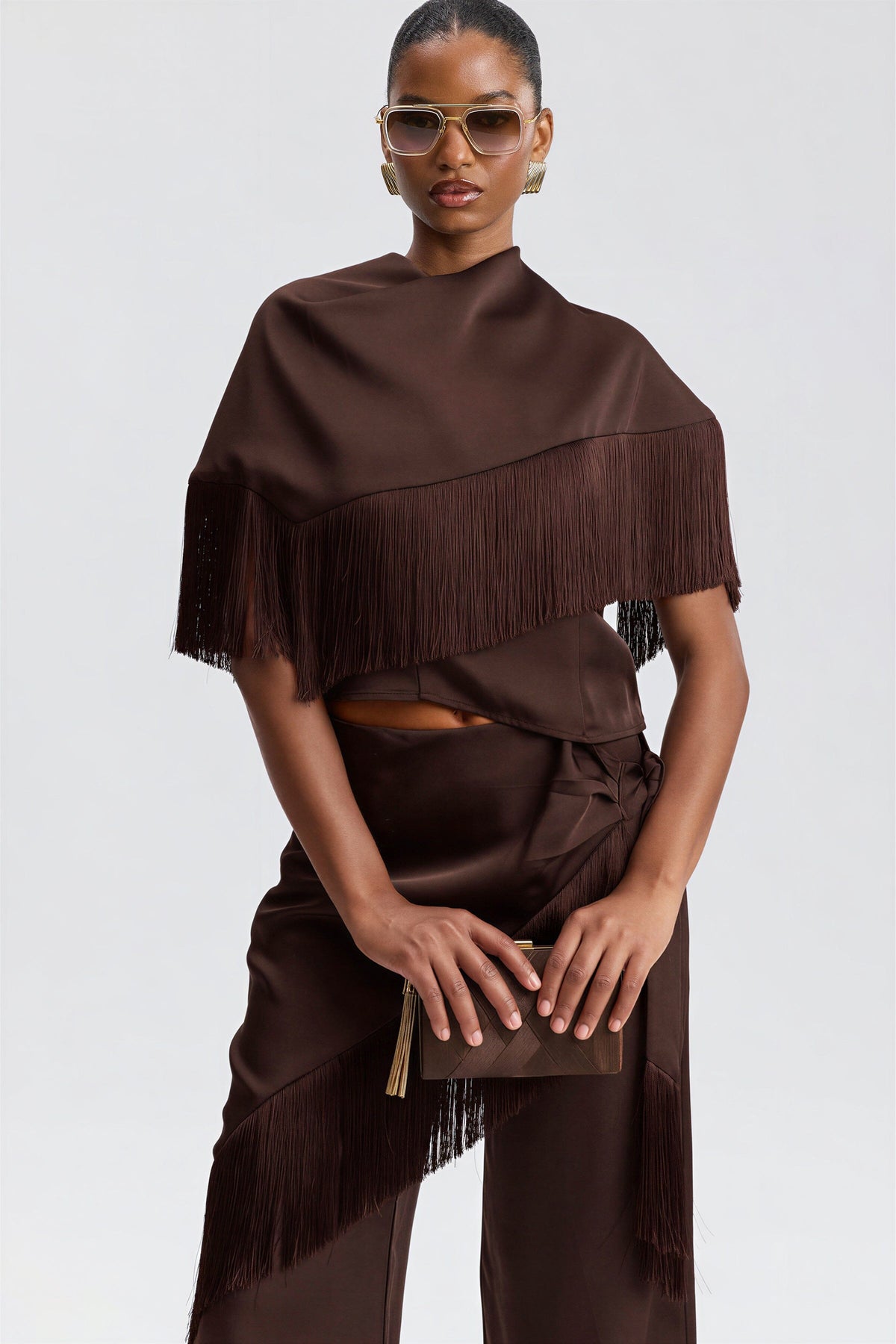 Satin scarf-neck brown halter fringe top with an asymmetric bandana-style cape. Shop brown tops by Avec Les Filles.