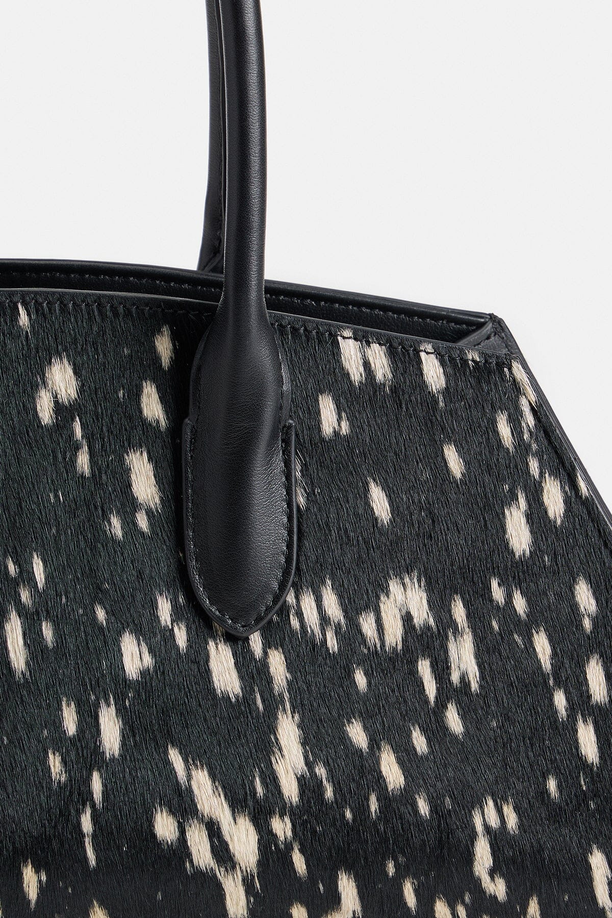 Black and white ponyhair bag with dual leather top handles - Shop women's pony hair bags by Avec Les Filles.