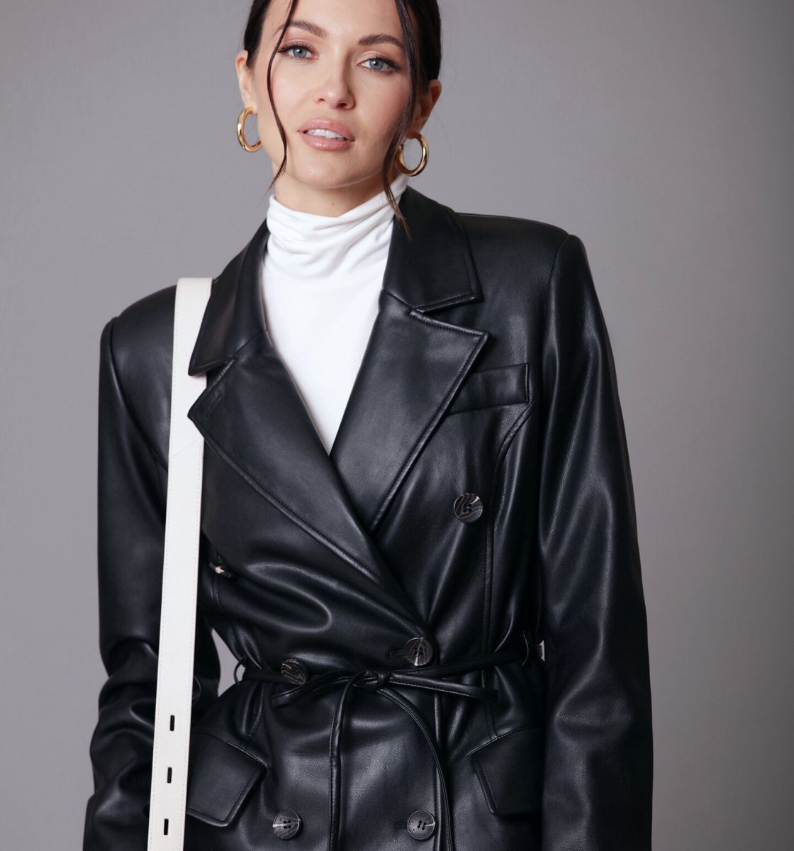 Black faux leather belted long trench coat by Avec Les Filles