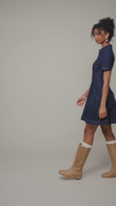 Cotton denim short-sleeve dark blue mini shirtdress with v-neck, side pockets and flared mini-length skirt. Cute women's shirt dresses by Avec Les Filles.