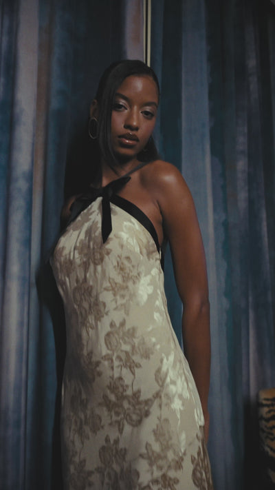Jacquard cream halter maxi dress with black satin straps and a bow neck. Shop cute backless dresses by Avec Les Filles.